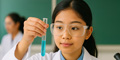 Female student in science lab at Bangkok school conducting experiment